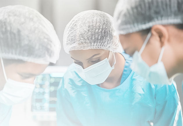 Doctors in a working environment wearing head covers, disposable masks, and body gowns, highlighting Nixxie Trades Sense Medical Care products.